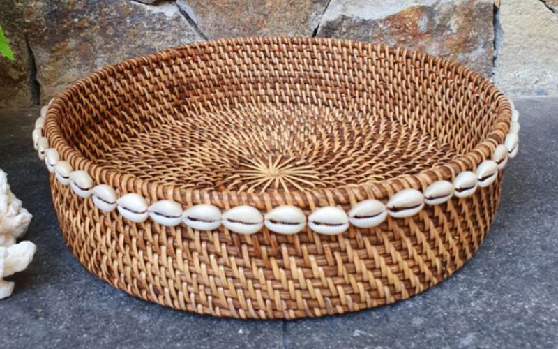 Woven rattan tray with cowrie shells